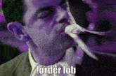 a man in a suit and tie is biting a piece of paper with the words order lob written below him .