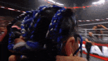 a close up of a person 's head with blue dreadlocks