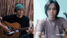 a man wearing headphones is playing a guitar next to another man