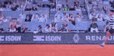 a tennis match is being played in front of a crowd that is sponsored by renault and isdin