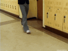 a person walking down a hallway next to lockers with the website junkpunks.tumblr.com at the bottom