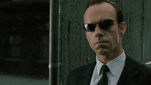 a man in a suit and tie says me too in a movie scene