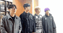 a group of young men standing next to each other with one wearing a sweater that says ' supreme ' on it