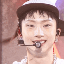 a close up of a person wearing a hat and a microphone .