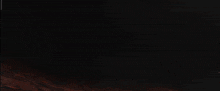 a video game character is holding a machine gun in front of an explosion