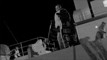 a man wearing a life vest is standing on a boat