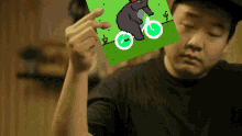 a man holding a picture of a bear riding a bike