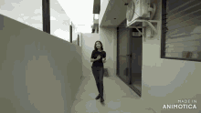 a woman standing in a hallway with the words made in animotica on the bottom right