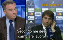 a man in a suit and tie talks into a microphone with the words secondo me devi cambiare lavoro