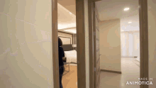 a woman standing in a hallway with the words made in animatica on the bottom right