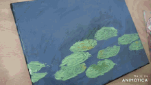 a person is painting on a canvas with a spoon and the words made in animotica behind them