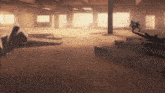 a group of people are standing in a warehouse with a plane in the background .