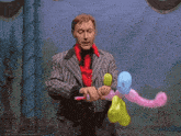 a man in a striped suit is making balloons