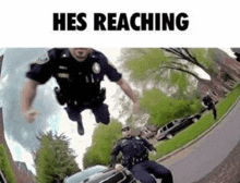 two police officers are jumping in the air while riding a motorcycle in front of a car .