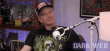 a man is sitting in front of a microphone wearing a t-shirt that says jetforce