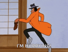 a cartoon character in an orange coat and hat is running in a room .