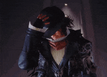 a man with a hat on his head is wearing a black coat