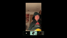 a person wearing a green hoodie that says california