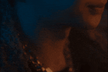 a close up of a person 's face with a blue background