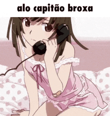 a girl in a pink dress is talking on a telephone