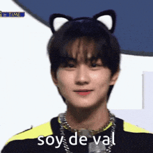 a young man wearing a cat ear headband with the words soy de val written on it