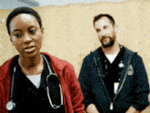 a woman with a stethoscope around her neck is standing next to a man in a blue jacket