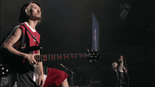 a man playing a guitar with a tattoo on his arm that says ss