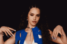 a woman in a blue and white dress is dancing