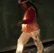 a person in a red shirt and white pants is walking