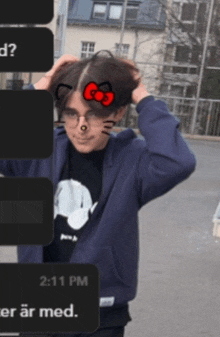 a person wearing a hello kitty sticker on their head
