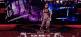 a female wrestler named sasha banks '16 is on a stage