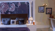 a bedroom with a large floral wallpaper on the wall above the bed