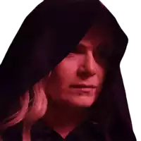 a woman wearing a black hood with a red light shining on her face