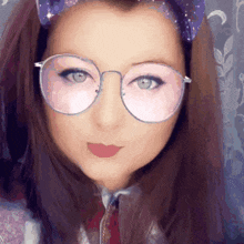 a close up of a woman wearing glasses and a bow