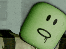 a green square with a smiley face and a tear coming out of it