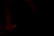 a blurry picture of a person sitting in a chair in a room .