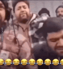 a group of men are laughing and crying in a video