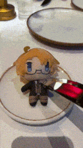 a stuffed doll with glasses is on a plate