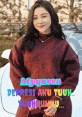 a woman in a maroon sweater stands in front of a white car with the words myqueen deprest aku tuuh
