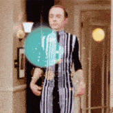 a man in a striped suit stands in a hallway