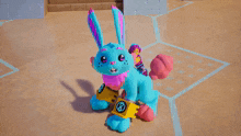 a blue and pink stuffed bunny with a yellow triangle on its chest