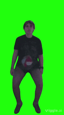 a man in a black shirt and shorts is dancing on a green screen ..
