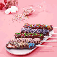 a tray of chocolate covered marshmallows with sprinkles on them