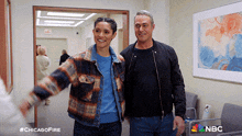 a man and a woman are walking down a hallway with the hashtag #chicagofire on the bottom