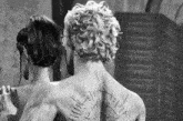 a black and white photo of a man and woman