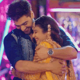 a man with a watch on his wrist is hugging a woman