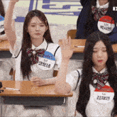 a girl wearing a name tag that says triples 511