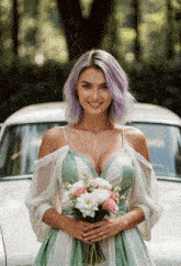 a woman in a green and white dress holding a bouquet of flowers