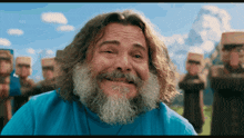 a man with long hair and a beard wearing a blue shirt