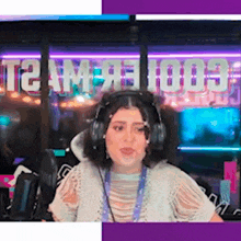 a woman wearing headphones in front of a sign that says t2am